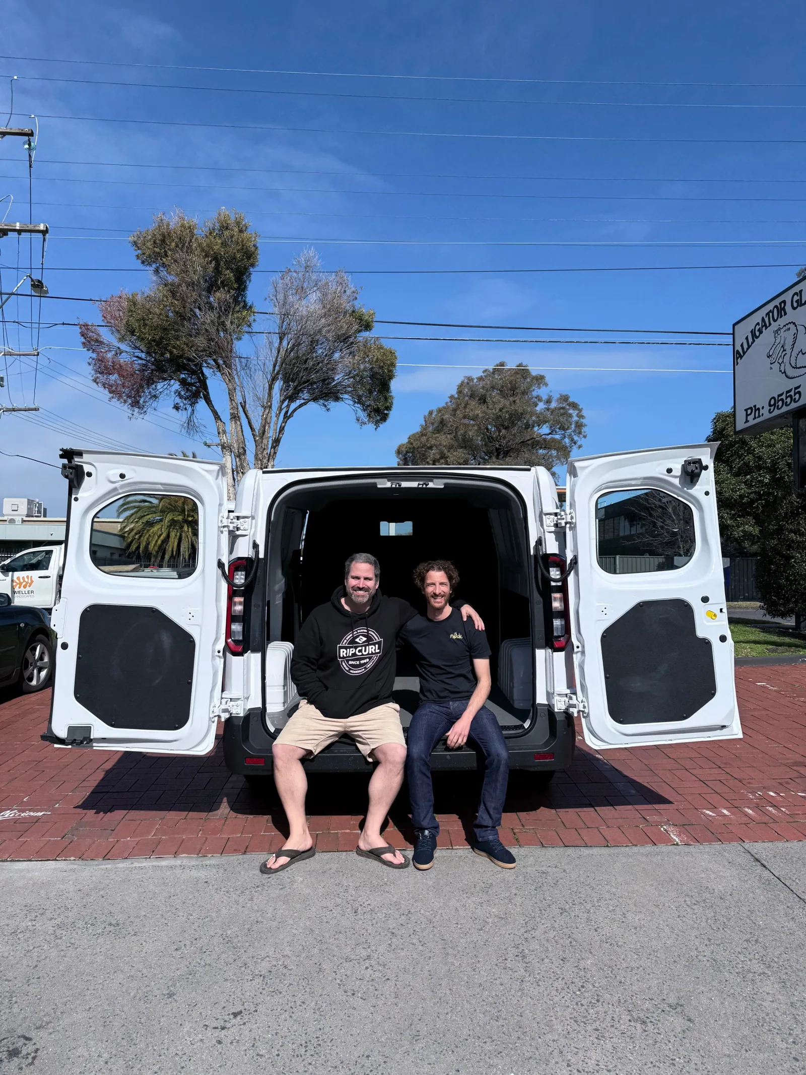 James and Scott sitting in the back of a Farizon electric van.